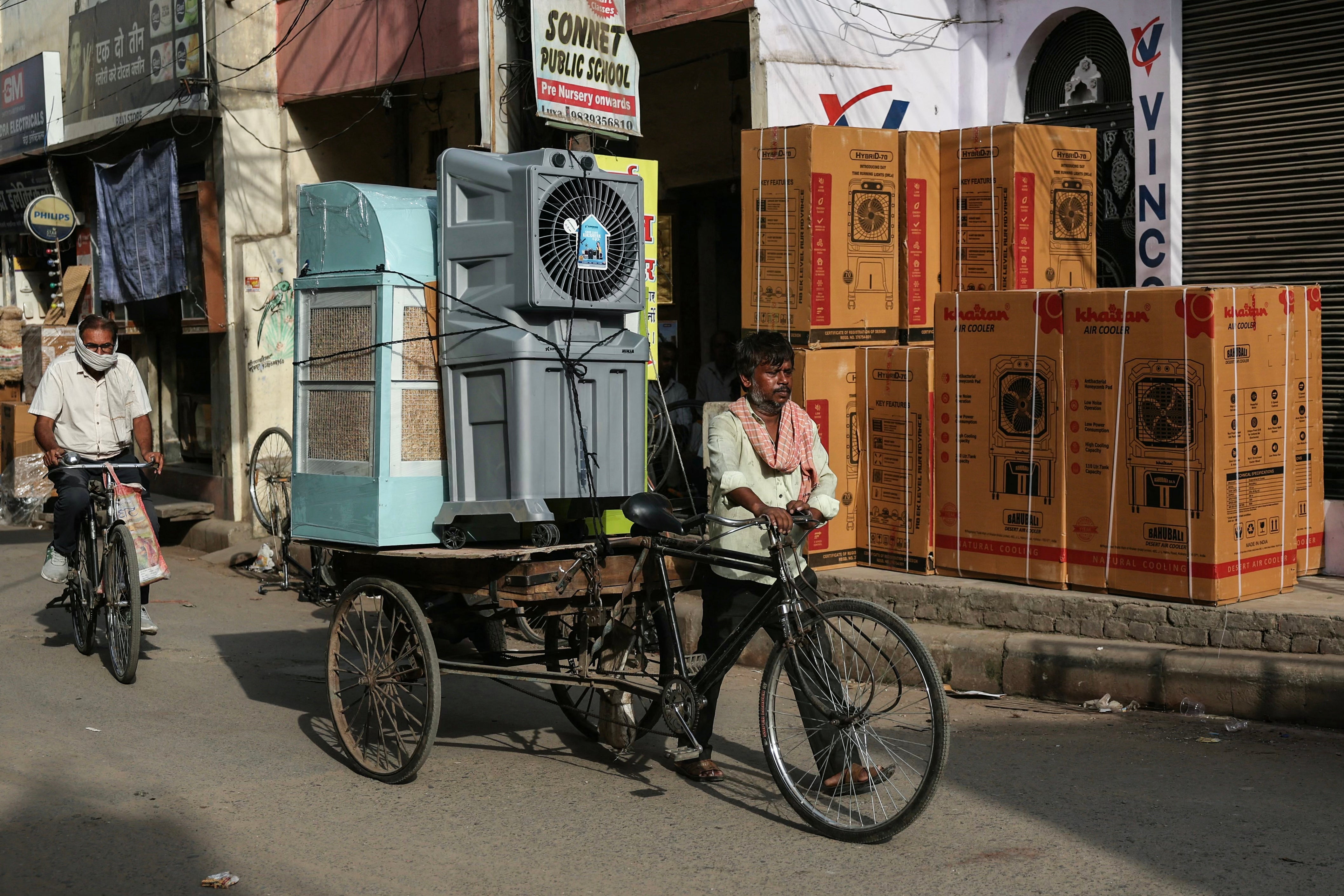 A man carries air coolers during a severe heat wave in the Indian city of Varanasi